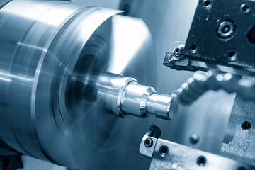 The  CNC lathe machine thread cutting the screw metal shaft parts. The hi-technology metal working processing by CNC turning machine .