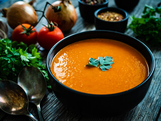 Cream tomato soup on wooden table
