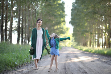 Mother with daughter walking on a road