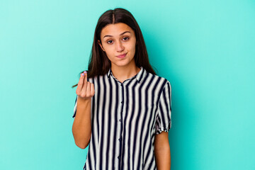Young Indian woman isolated on blue background showing that she has no money.