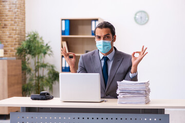 Young male employee wearing mask during pandemic