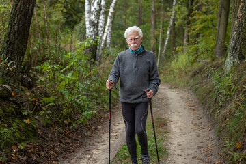 Handsome elderly man enjoying his nordic walking workout