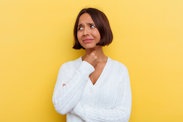Fototapeta premium Young mixed race woman isolated on yellow background suffers pain in throat due a virus or infection.
