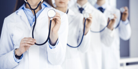 Group of doctors holding stethoscope head close-up. Physicians ready to examine and help patient. Medicine concept