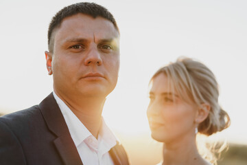 Portrait of a bride and groom in a sunset light