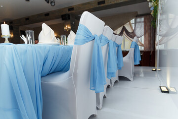 Beautiful blue and white wedding presidium for just married, arm-chairs with decorative fabric