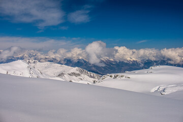 Fototapeta na wymiar Landscape panoramic view of the ski resort of Verbier, with snowy Alps in the background, shot in Verbier, Bagnes, Valais, Switzerland