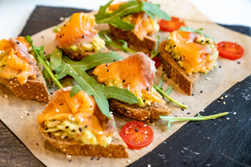 baguette with salmon. A convenient buffet feed. little sandwiches at the festival. Catering. delivery of ready meals and service of banquets.