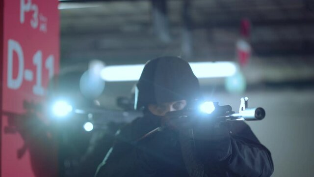 Special assault team targeting scopes on modern rifles with flashlights
