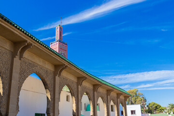 Fragment of arcade gallery of Sidi Bou Abib Mosque against blue sky in Tangier, Morocco.