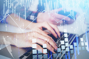 Businesswoman or stock trader analyzing stock graph chart, side view business woman using laptop to buy or sell stock, internet trading. Blurred businessman on background