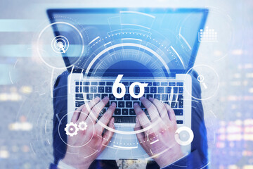 Top view of businessman hands working on laptop and researching six sigma, quality control and manufacturing process management concept in business. virtual interface with cogwheels.