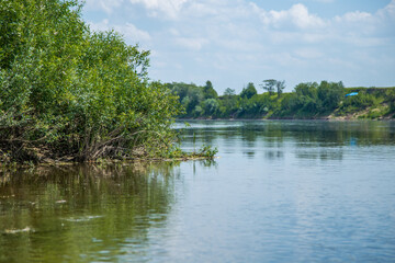 View of the Oka river from the shore, the opposite Bank is visible . The sky is reflected in the water