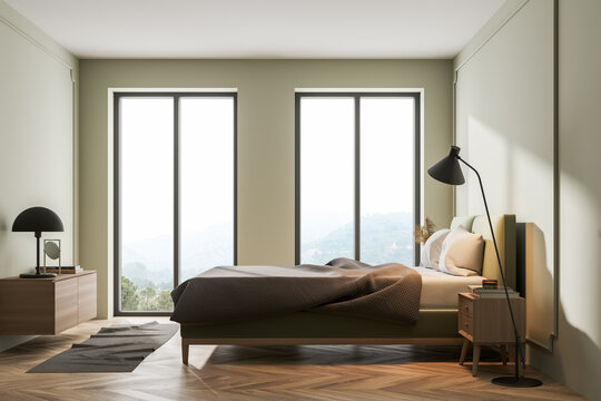 Light bedroom interior with bed, linens and window