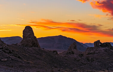 Sunset over Pinnacles with mountain beyond.