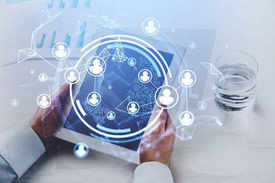 Young businessman wearing white shirt is holding tablet