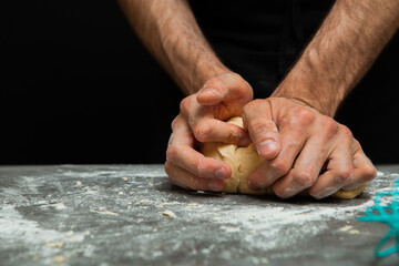 person kneading dough