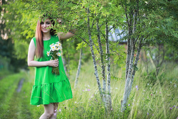 beautiful girl with red hair with a bouquet