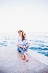 Fototapeta na wymiar Cheeful woman relaxing by the sea
