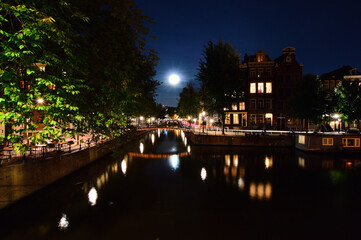 The moon over the Amsterdam canals at night. Summer. Night.