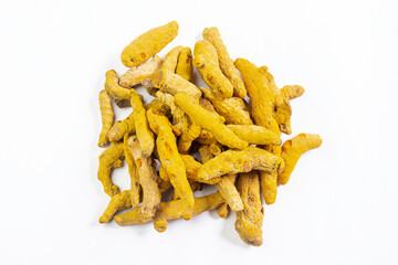 Dry turmeric or haldi roots on white isolated background.