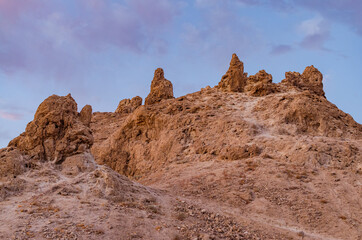 Pinnacles on hilltop in desert.
