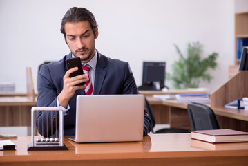 Young man businessman employee sitting in the office