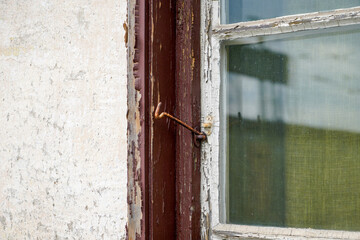 Old wooden frame and broken glass window on an old building for renovation
