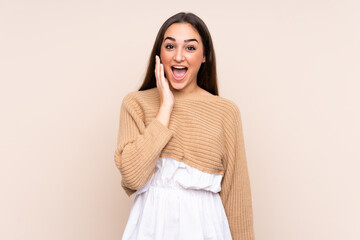 Young caucasian woman isolated on beige background with surprise and shocked facial expression