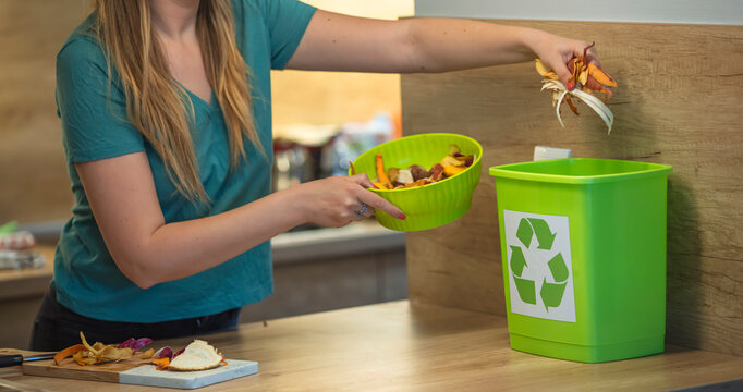 Domestic waste for compost from fruits and vegetables. Woman throws garbage. Millennial young woman recycling compost from kitchen waste. Circular economy, real food, organic waste