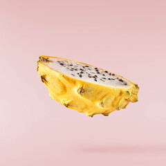 creative image with fresh yellow pitaya falling in the air, zero gravity food conception