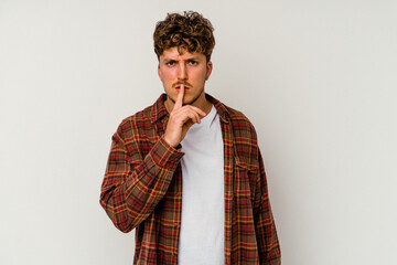 Young caucasian man isolated on white background keeping a secret or asking for silence.