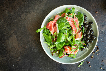 salad ham pork meat Dry meat jamon Italian Prosciutto Serrano, Bellota, Crudo or Parma portion on the table meal top view copy space healthy food background