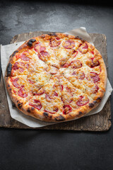 pizza sausage tomato sauce cheese trend fast food meal copy space rustic food background 