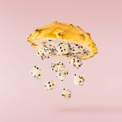 creative image with fresh yellow pitaya falling in the air, zero gravity food conception