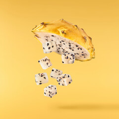 creative image with fresh yellow pitaya falling in the air, zero gravity food conception
