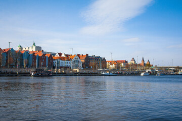 view of the old town, view of the city center, river and passing boat, wooden platform before modern city