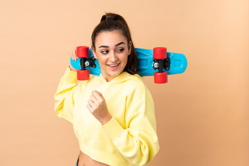 Young caucasian woman isolated on pink background with a skate with happy expression