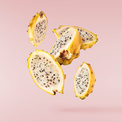 creative image with fresh yellow pitaya falling in the air, zero gravity food conception