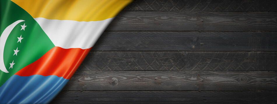 Comorian flag on black wood wall banner