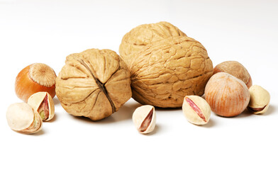 Walnuts, hazelnuts and pistachios on a white background. Nut - a source of vitamins and useful trace elements. For a healthy and vegetarian diet.