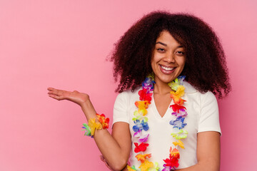 Young african american woman wearing a hawaiian stuff showing a copy space on a palm and holding...
