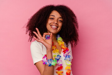 Young african american woman wearing a hawaiian stuff cheerful and confident showing ok gesture.