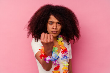 Young african american woman wearing a hawaiian stuff showing fist to camera, aggressive facial...