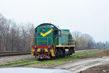 Fototapeta na wymiar Railroad locomotive rides on the railroad without wagons