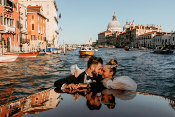 Evening boat trip along the sea bay. Newlyweds travel to Venice. Warm summer evening.