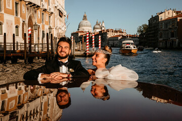 Evening boat trip along the sea bay. Newlyweds travel to Venice. Warm summer evening.