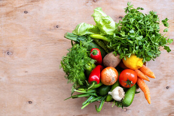Fresh Vegetables in basket on wooden table. Top view.