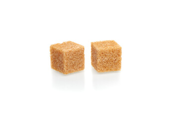 Brown cubes of cane sugar isolated on white background. Close up view.