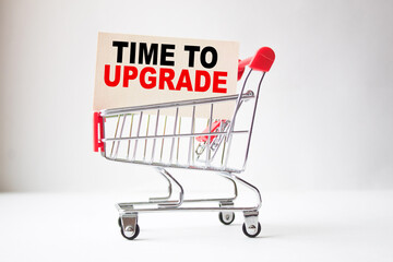 a business card with text TIME TO UPGRADE in a shopping cart. business and finance